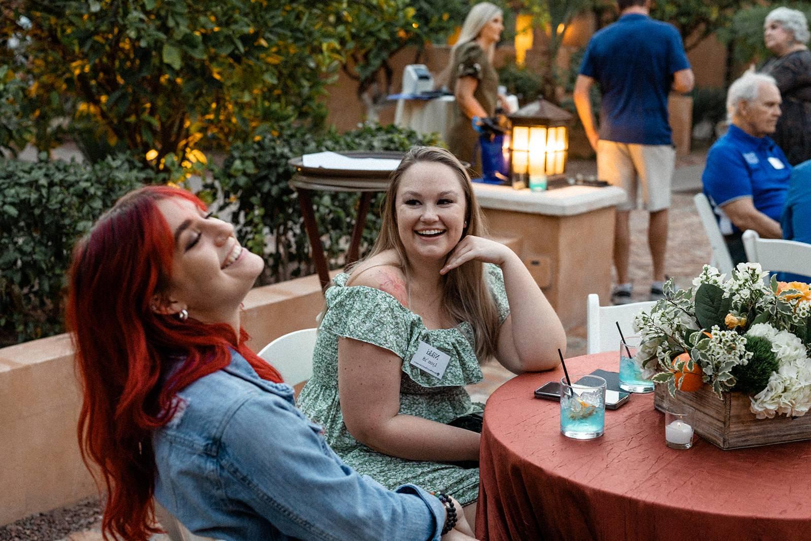 Two alums smile during an event in Phoenix